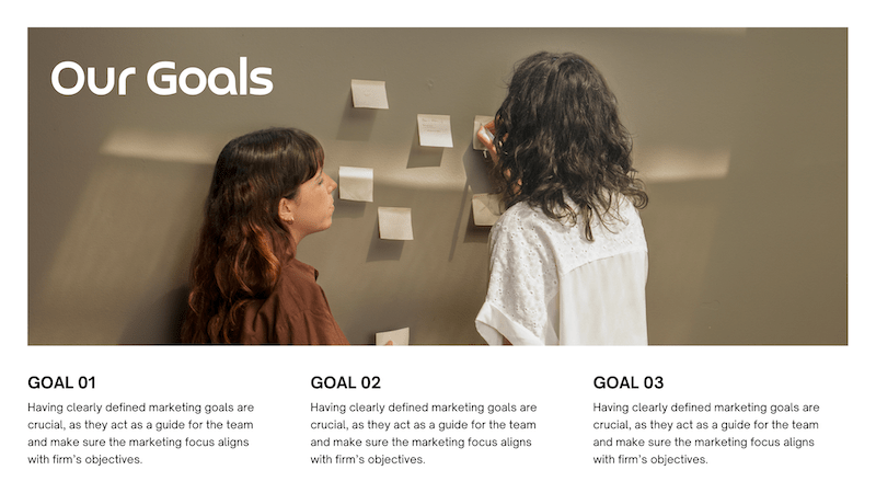 "our goals" label over image of two women reviewing post its on wall 